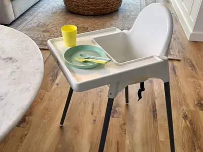 a white high chair with a plate and a cup on it at Atlantis View 1BR with Beachfront Access and Balcony in Dubai