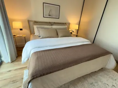a bedroom with a large bed and two lamps at Atlantis View 1BR with Beachfront Access and Balcony in Dubai