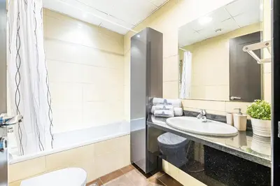 a bathroom with a sink and a mirror at Luxe Studio with Upgraded Interior in Sports City in Dubai