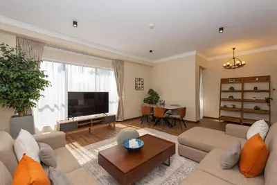 a living room with a couch and a tv at Rimal 4, JBR- Elegant 2 BR in Dubai