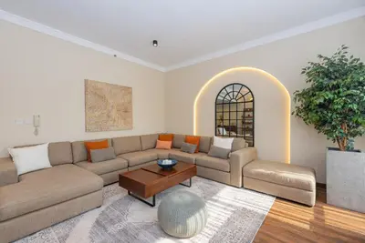 a living room with a couch and a table at Rimal 4, JBR- Elegant 2 BR in Dubai