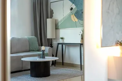 a living room with a couch and a table at Moderne 1BR with a lovely marina view in Dubai