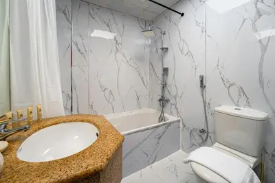 a bathroom with a sink and a toilet and a tub at Moderne 1BR with a lovely marina view in Dubai