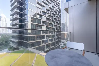 a room with a table and a large building at Spacious 3 Bedroom Apartment in Downtown with Burj Khalifa view in Dubai