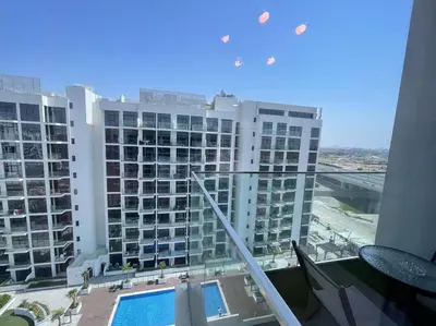 a view of a large apartment building with a swimming pool at Studio in Azizi Riviera 47 in Dubai