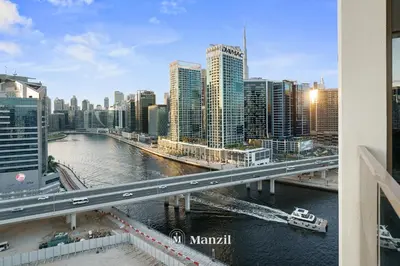 a bridge over a river in a city with buildings at Lux 2BR Apartment Near Dubai Mall & Burj Khalifa in Dubai