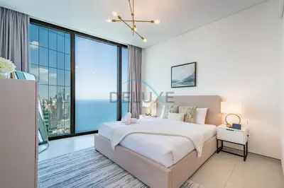 a bedroom with a large bed and a large window at Grand 3BR Aparment at The Address Residences in JBR by Deluxe Holiday Homes in Dubai