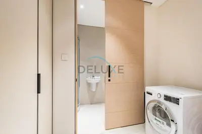 a washer and dryer in a bathroom with a sign at Grand 3BR Aparment at The Address Residences in JBR by Deluxe Holiday Homes in Dubai