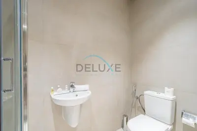 a bathroom with a white toilet and a sink at Grand 3BR Aparment at The Address Residences in JBR by Deluxe Holiday Homes in Dubai