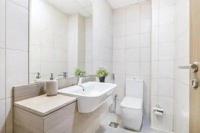a white bathroom with a sink and a toilet at Elegant Home next to Metro Station in Al Furjan in Dubai