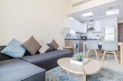 a living room with a couch and a table at Elegant Home next to Metro Station in Al Furjan in Dubai