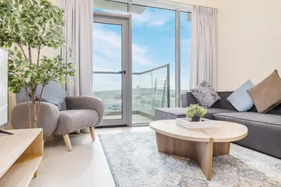 a living room with a couch and a table at Elegant Home next to Metro Station in Al Furjan in Dubai