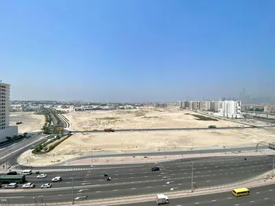 an aerial view of a highway with a parking lot at Modern Studio Close To Metro in Dubai