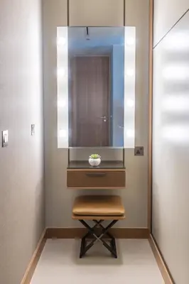 a dressing table with a stool and a mirror at Frank Porter - The Address Opera Residences in Dubai