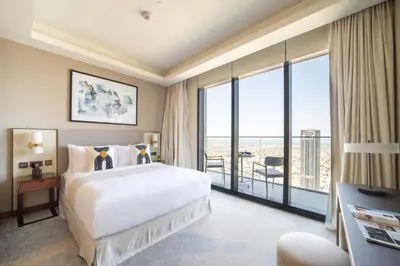 a hotel room with a bed and a large window at Frank Porter - The Address Opera Residences in Dubai