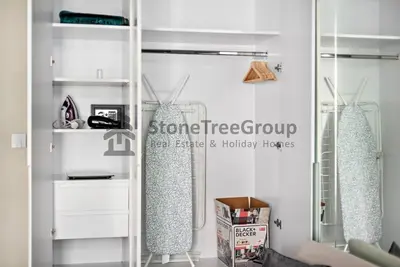 a room with white shelves and a glass door at Luxury Studio Near To Metro in Dubai