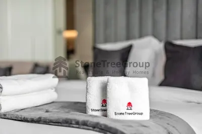 a pile of towels on a table in a hotel room at Luxury Studio Near To Metro in Dubai