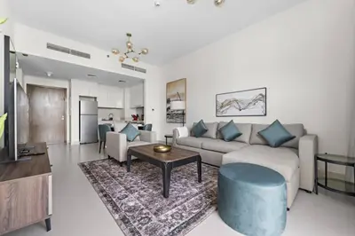 a living room with a couch and a table at Modern 1 Br Near To Park in Dubai