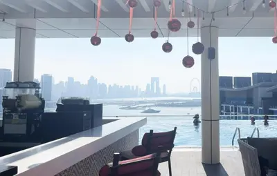 a restaurant with a view of a body of water at Seven Palm Hotel with West beach access in Dubai