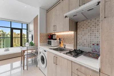 a kitchen with a sink and a stove at Seven Palm Hotel with West beach access in Dubai