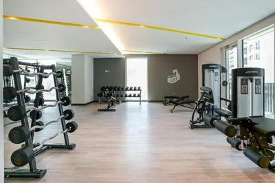 a gym with lots of treadmills and weights at Creek Edge - One Bedroom with Partial Sea View in Dubai