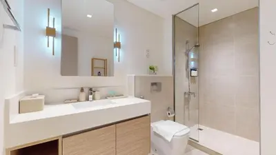 a bathroom with a sink and a toilet and a shower at Creek Edge - One Bedroom with Partial Sea View in Dubai