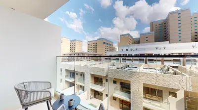 a balcony of a building with a chair at Avanos Residence - Captivating Studio in JVC in Dubai