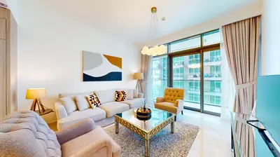 a living room with a couch and a table at Beach Vista 2 - Two Bedroom with Partial Sea View in Dubai