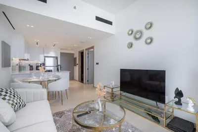 a living room with a couch and a large television at Luxurious 1-Bedroom Oasis l Binghatti Corner, JVC in Dubai