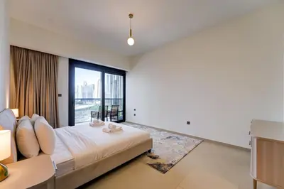 a bedroom with a bed and a large window at Stylish 2 Bed with Stunning Burj Khalifa View in Downtown in Dubai