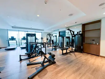 a gym with treadmills and ellipticals in a building at Stylish 2 Bed with Stunning Burj Khalifa View in Downtown in Dubai