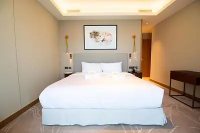a large white bed in a hotel room at Gorgeous High Floor 3-Bed with Full Burj View in Dubai