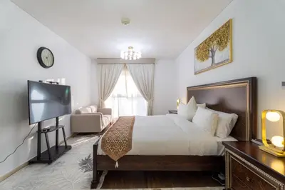 a bedroom with a bed and a flat screen tv at Veer Apartments - 87th Floor Penthouse Full Sea View 5 BHK in Dubai