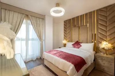 a bedroom with a large bed and a large window at Veer Apartments - 87th Floor Penthouse Full Sea View 5 BHK in Dubai