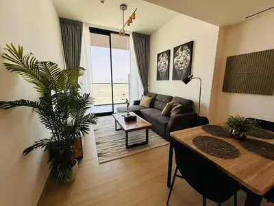 a living room with a couch and a table at Stylish 1br Apt Jvc W Pool & Free Parking in Dubai