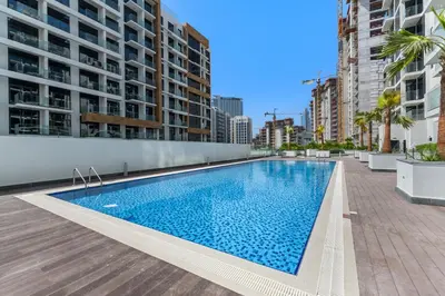 a swimming pool in a building with tall buildings at Elegant Studio with Pool Access & Private Terrace in Dubai