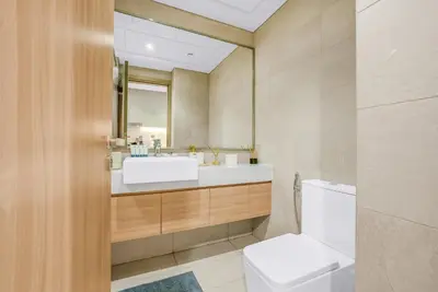 a bathroom with a sink and a toilet at Elegant Studio with Pool Access & Private Terrace in Dubai