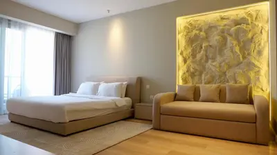 a bedroom with a bed and a couch at Splendid Cozy Studio - Address Dubai Marina in Dubai