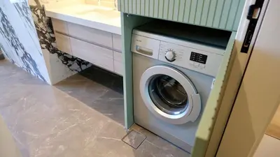 a washing machine in a kitchen next to a counter at Splendid Cozy Studio - Address Dubai Marina in Dubai