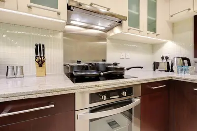 a kitchen with two pots and pans on a stove at Chic City Apartment in Dubai Gym, Pool, and Free Parking in Dubai