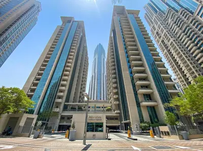 two tall buildings in front of a city at Chic City Apartment in Dubai Gym, Pool, and Free Parking in Dubai