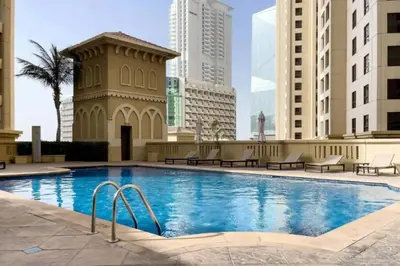 a swimming pool in the middle of a city with buildings at 4BR Jumeirah Beach Stay with Dubai Eye Views & Near Marina Walk in Dubai