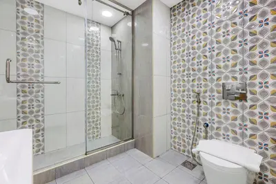 a bathroom with a shower and a toilet at 4BR Jumeirah Beach Stay with Dubai Eye Views & Near Marina Walk in Dubai
