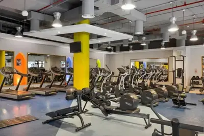 a gym with rows of treadmills and ellipticals at 4BR Jumeirah Beach Stay with Dubai Eye Views & Near Marina Walk in Dubai