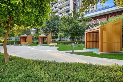 a park with benches and trees and a building at FIRST CLASS 2BR Serene Retreat in Wilton in Dubai