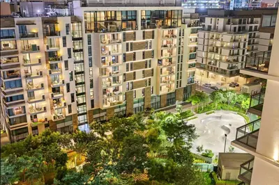 an aerial view of an apartment complex at night at FIRST CLASS 2BR Serene Retreat in Wilton in Dubai