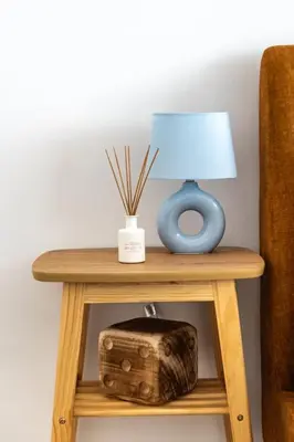 a table with a lamp and a box on it at GuestReady - Elegant retreat at Damac Hills in Dubai