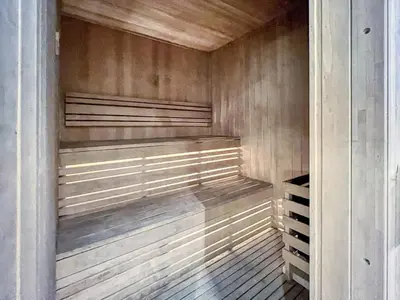 a walk in closet with wood paneling at GuestReady - Elegant retreat at Damac Hills in Dubai