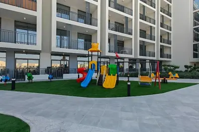 a playground in front of a apartment building at TOP Location and Work and Chill near Miracle Garden in Dubai
