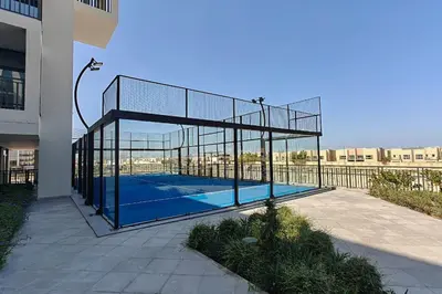 a tennis net with a tennis court in a building at TOP Location and Work and Chill near Miracle Garden in Dubai